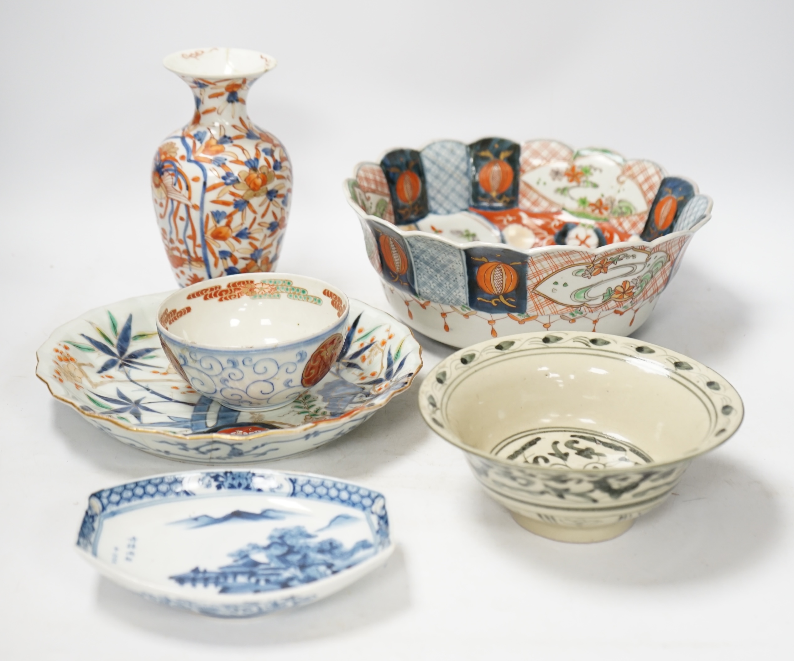 Japanese ceramics to include an Imari vase and bowl and a blue and white dish, 22cm diameter. Condition - two bowls and dish good, others poor